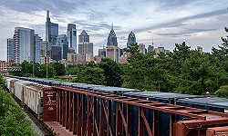 Freight train with city in the background