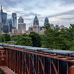 Freight train with city in the background